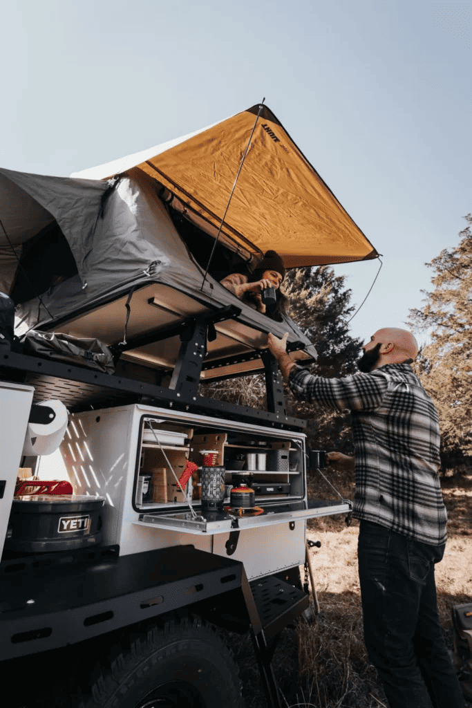 Couple using Wooly Bear TAXA Outdoors off-road trailer