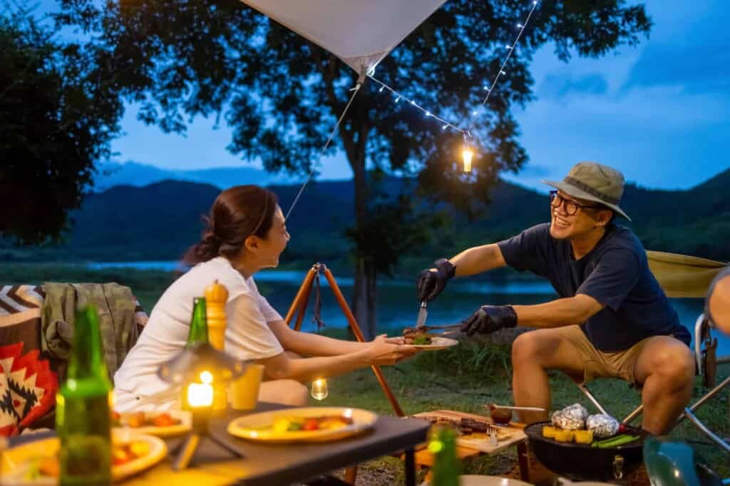 couple eating camping cooking meal