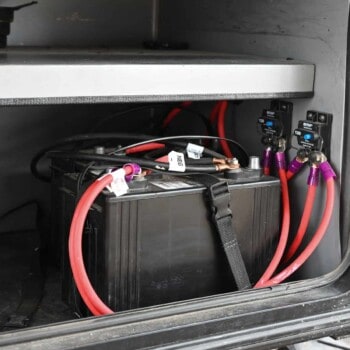 RV house battery in camper storage compartment