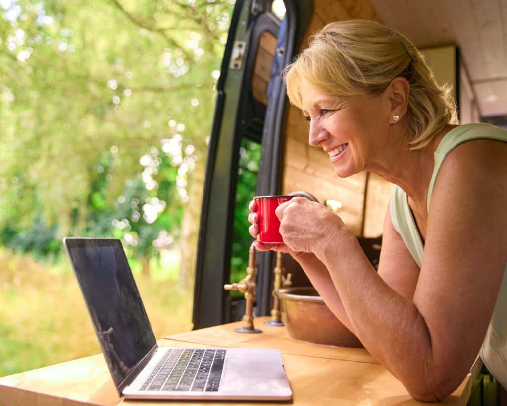 woman using low cost RV internet (Image: Shutterstock)