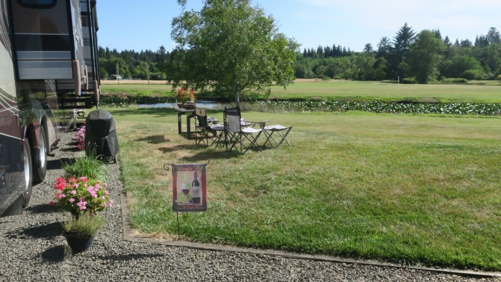 Motorhome with camping chairs and table at a premium site in the C loop of Lewis & Clark Golf & RV Park Oregon (Image: @VegasVagabonds, RV LIFE Campgrounds)