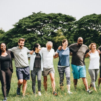 diverse group of mature people recreating outside on grass (Image: Shutterstock)